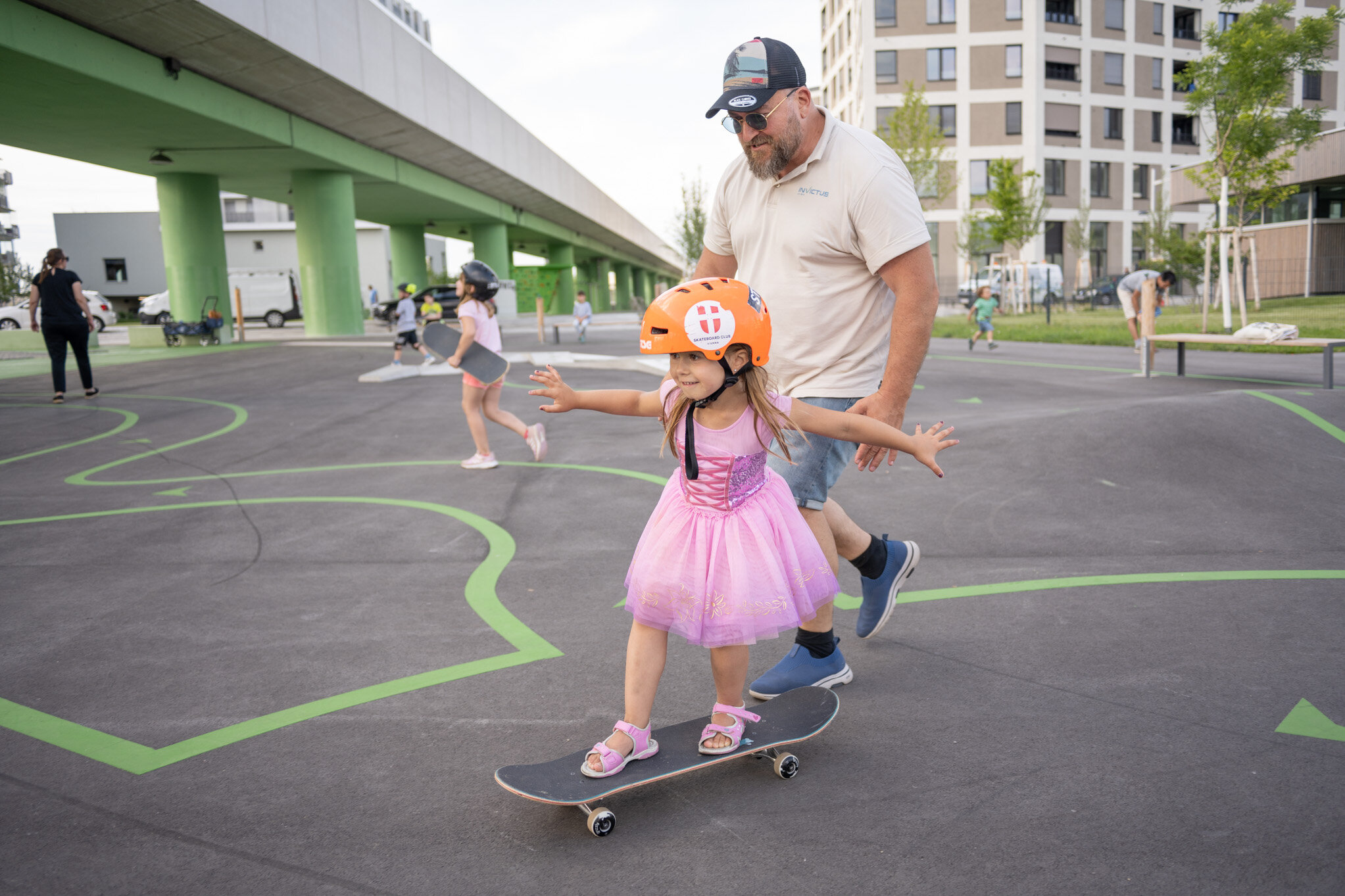 ein Mädchen mit Helm auf einem Skateboard