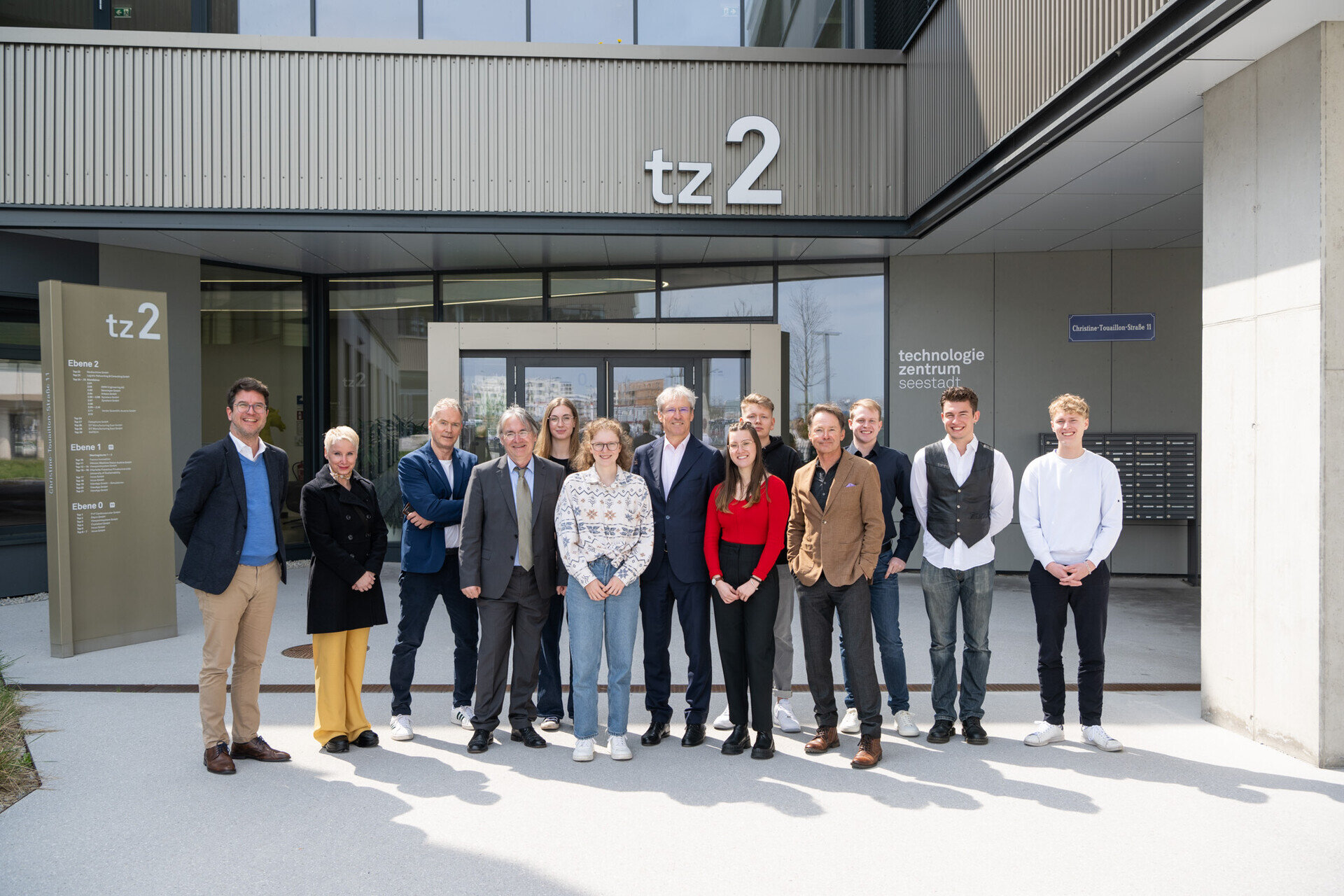 Charlotte-Fresenius-Privatuniversität im Technologiezentrum Seestadt. Mehrere Personen vor einem modernen Gebäude.