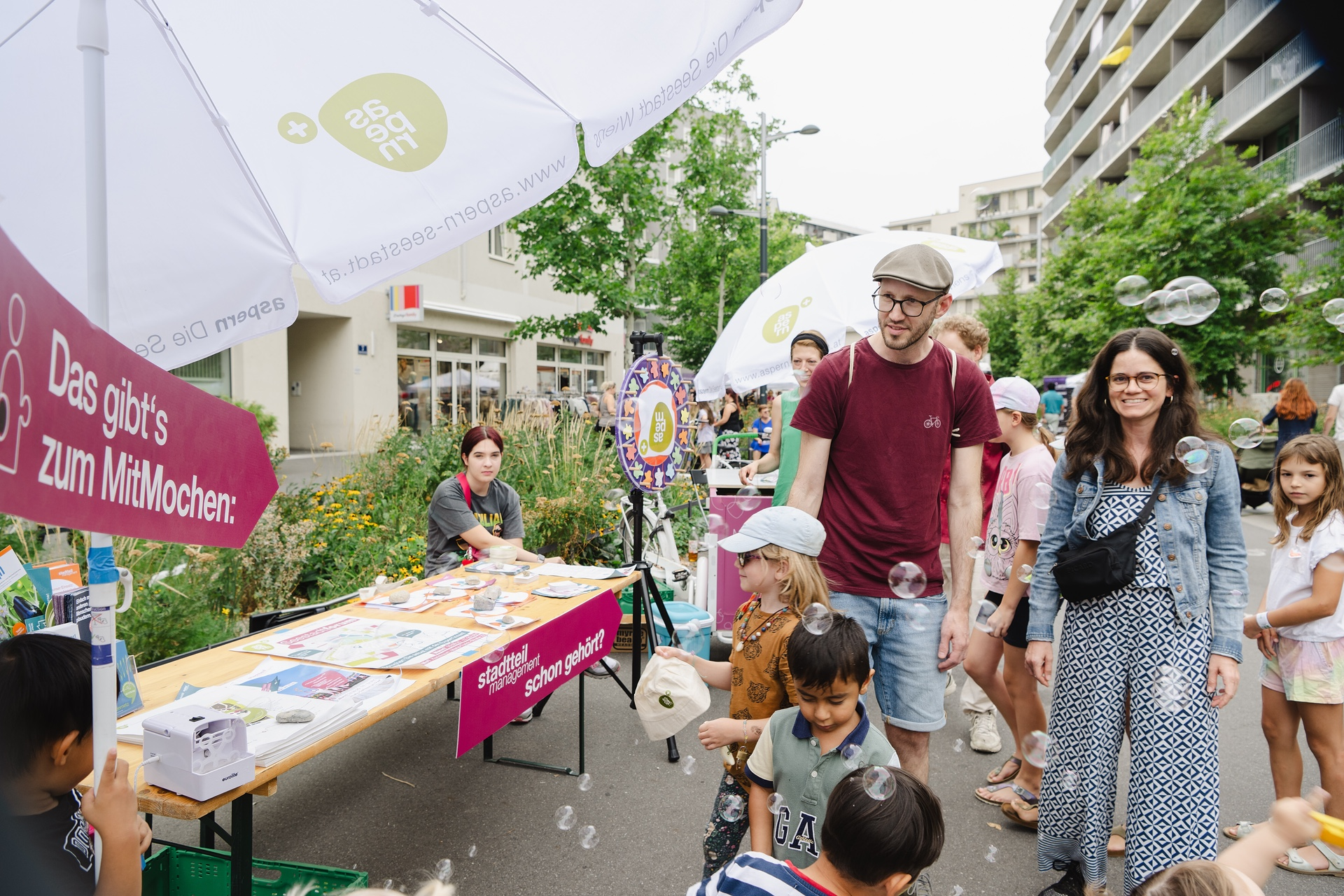 Das alljährliche Straßenfest der Seestadt ist beliebter Treffpunkt für die Nachbarschaft. Mehere Personen unterschiedlichen Alters auf einem Fest.