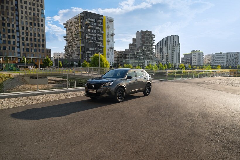 Ein Auto von SHARE NOW vor der Seestadt-Kulisse.