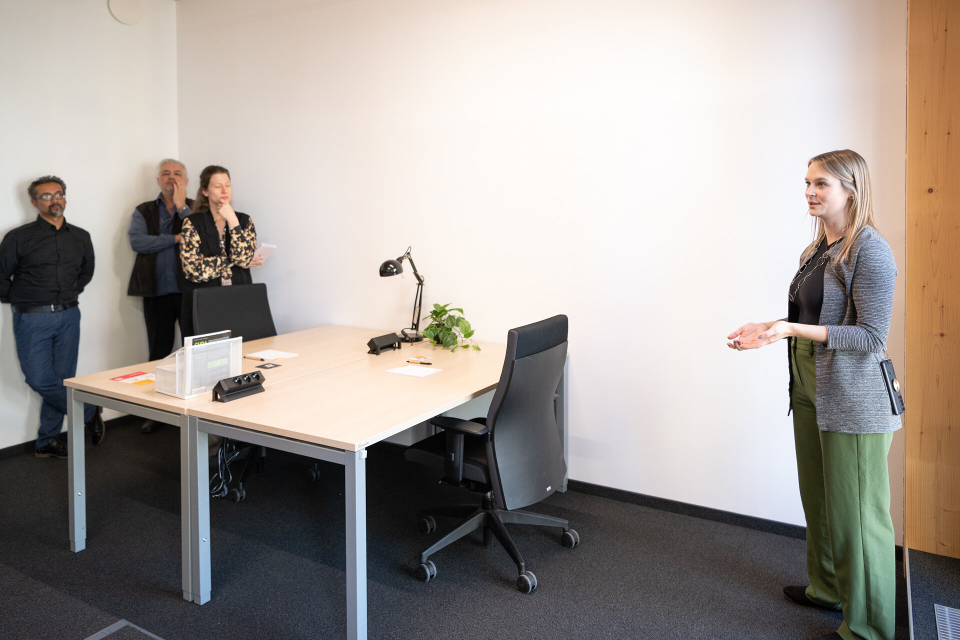 Menschen stehen um einen Schreibtisch